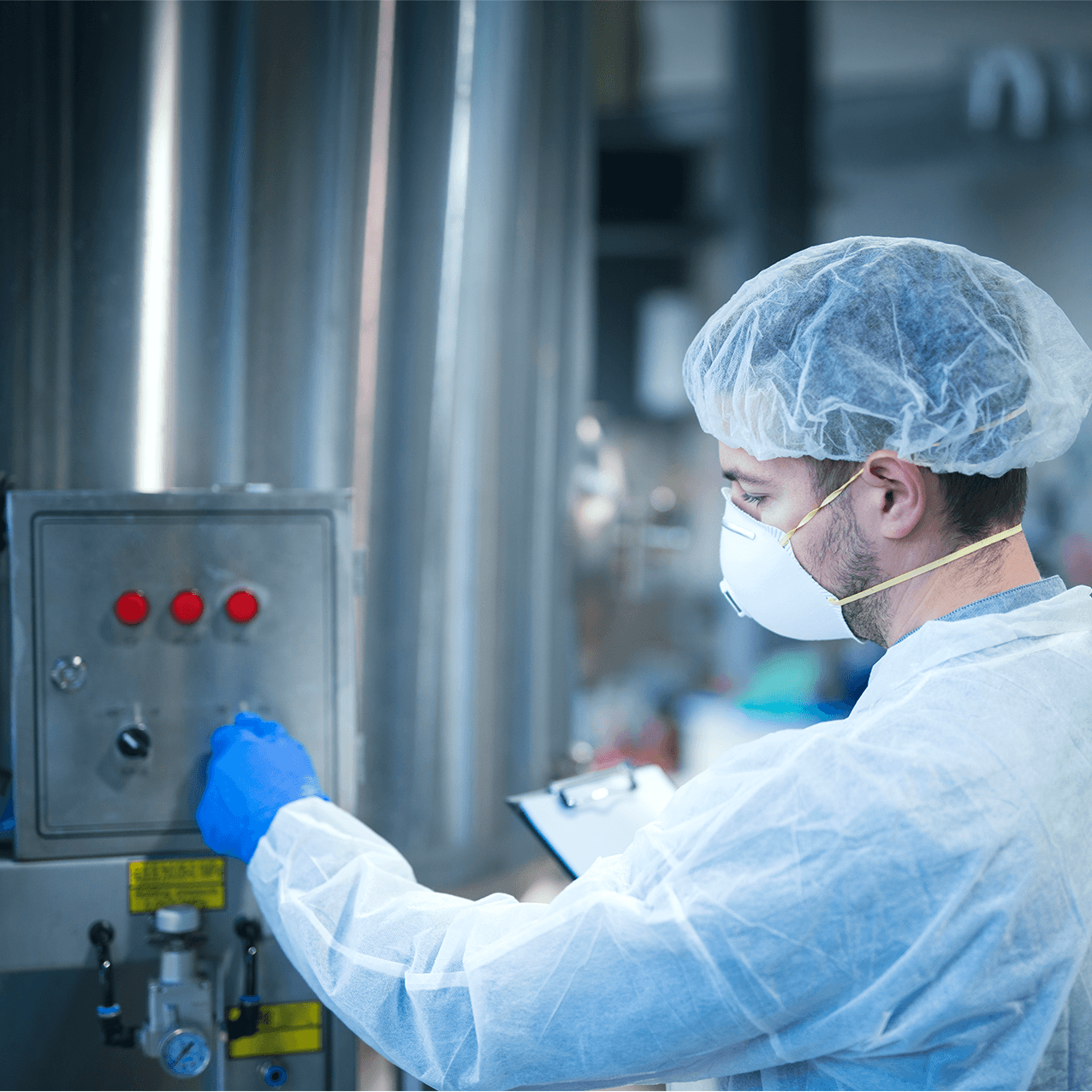 A pharmaceutical production worker inspecting bottles on a filling line